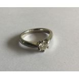 An 18 carat white gold single stone ring in claw m