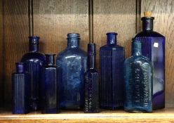 A group of blue glass bottles. Est. £10 - £20.