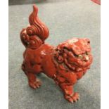 A stylish Chinese figure of a Dog of Foo in red gl