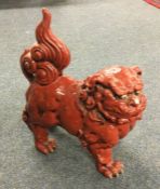 A stylish Chinese figure of a Dog of Foo in red gl