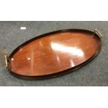 An oval brass mounted and mahogany tray. Est. £20