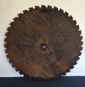 A massive metal saw blade. Est. £30 -£50.