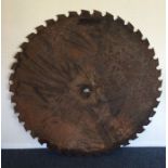 A massive metal saw blade. Est. £30 -£50.