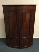 A Victorian mahogany bow front corner cupboard. Es