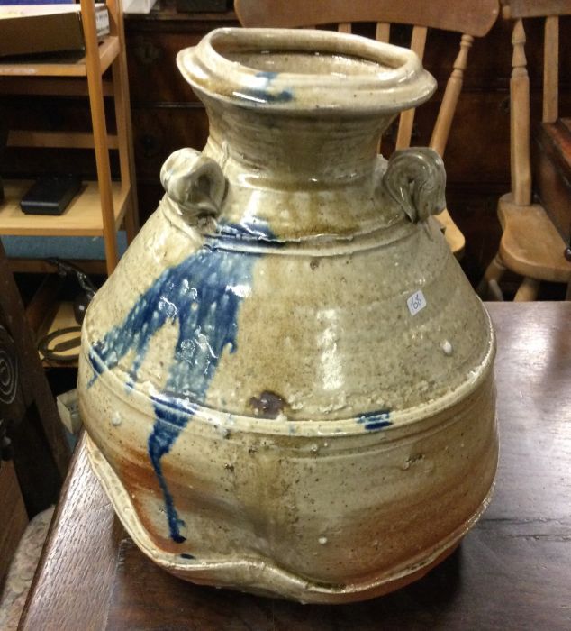 A stylish pottery vase decorated in reds and blues