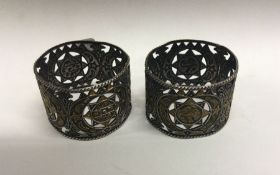 A pair of Turkish silver and enamel napkin rings. Approx. 62 grams. Est. £40 - £60.