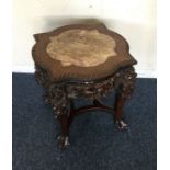 A Chinese plant stand with marble top. Est. £100 -