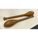 A pair of heavy wooden Indian juggling clubs. Est.