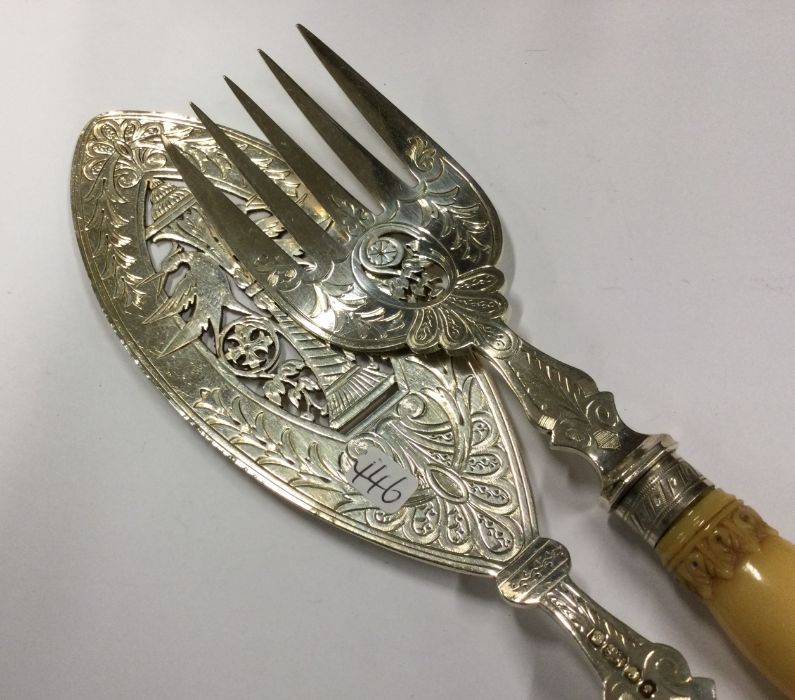 A pair of Victorian silver fish servers with pierc