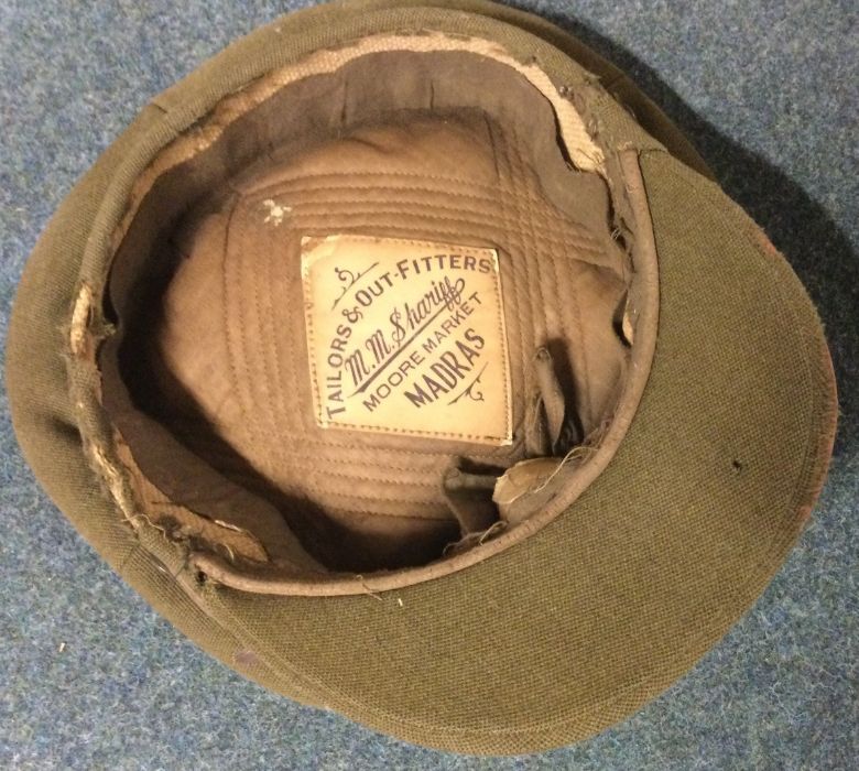 A World War I Officer's cap. Est. £10 - £20.