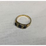 An 18 carat gold sapphire and diamond half hoop ri