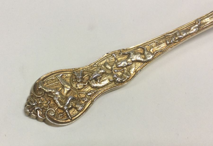 A fine quality silver gilt sauce ladle with chased scene to handle. Approx. 77 grams. Est. £100 - £ - Image 2 of 2