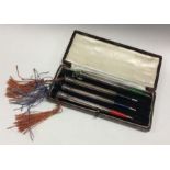 A set of four cased silver pencils. Approx. 36 grams. Est. £80 - £120.