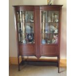 An Edwardian bow front display cabinet. Est. £100