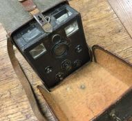 An old cased camera. Est. £20 - £30.
