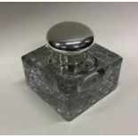A silver mounted glass inkwell. Birmingham 1906. Est. £60 - £80.