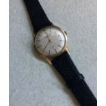 A gent's 9 carat wristwatch on leather strap. Est.