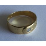 A gent's 18 carat gold buckle ring with single dia
