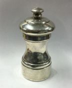 A silver pepper grinder of typical form. Approx. 1