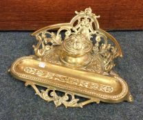 A heavy Victorian brass inkstand with pierced gall