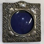 A silver pierced frame with floral decoration. Approx. grams. Est. £30 - £50.