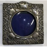 A silver pierced frame with floral decoration. Approx. grams. Est. £30 - £50.