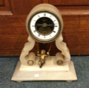 A hardstone mantle clock with brass and enamelled