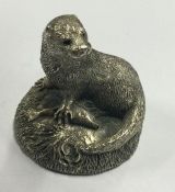 A silver figure of a seal and fish of textured form. Birmingham. Approx. 67 grams. Est. £50 - £80.