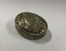 A chased Continental silver pill box. Approx. 21 g