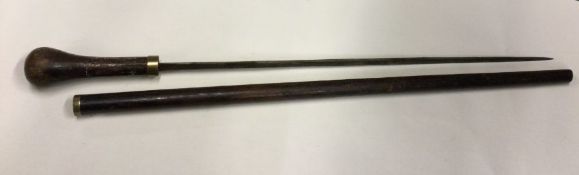 A mahogany and brass mounted sword stick. Est. £50