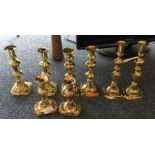 Four pairs of brass candle sticks. Est. £20 - £30.