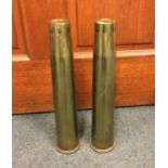 A pair of 40 mms brass shell cases together with t