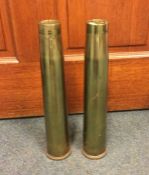 A pair of 40 mms brass shell cases together with t