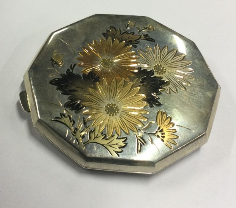 A finely engraved mixed metal Japanese compact. Approx. 97 grams. Est. £150 - £180.