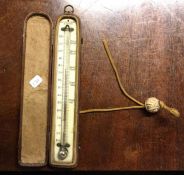 An Antique travelling thermometer in leather case.
