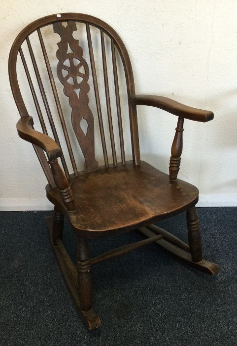 A bow back rocking chair. Est. £30 - £40.