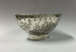 A circular silver bowl of Chinese design. Apparent