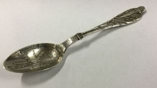 An unusual silver christening spoon decorated with