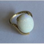 An opal single stone ring in 18 carat oval claw mo