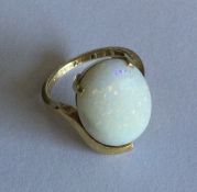 An opal single stone ring in 18 carat oval claw mo