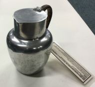 An aluminium RAF Millom exhibit jug with cane hand