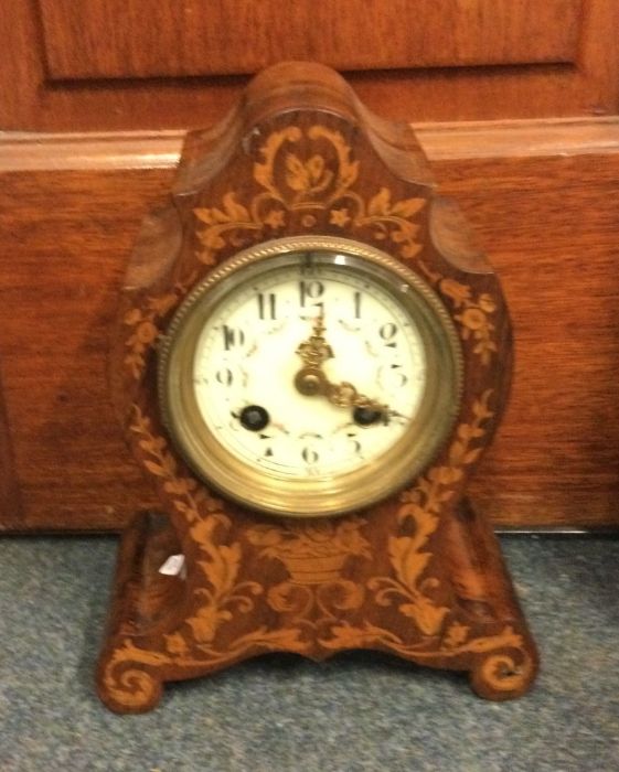 A Continental inlaid mantle clock with white ename