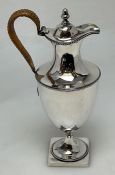 A Georgian silver ewer with cane handle to square