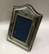 A silver picture frame with beaded border. London 1994. By BSC. Est. £30 - £50.