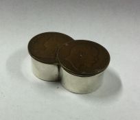 A heavy silver pill box mounted with coins. London