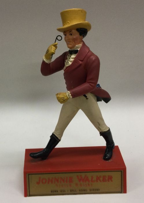 A novelty Johnny Walker figure. Est. £10 - £20.