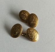 A pair of Victorian 15 carat gold engraved cufflin