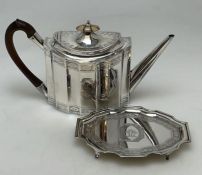 A heavy Georgian silver teapot on stand with woode