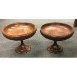 A turned mahogany fruit bowl together with one oth