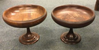 A turned mahogany fruit bowl together with one oth